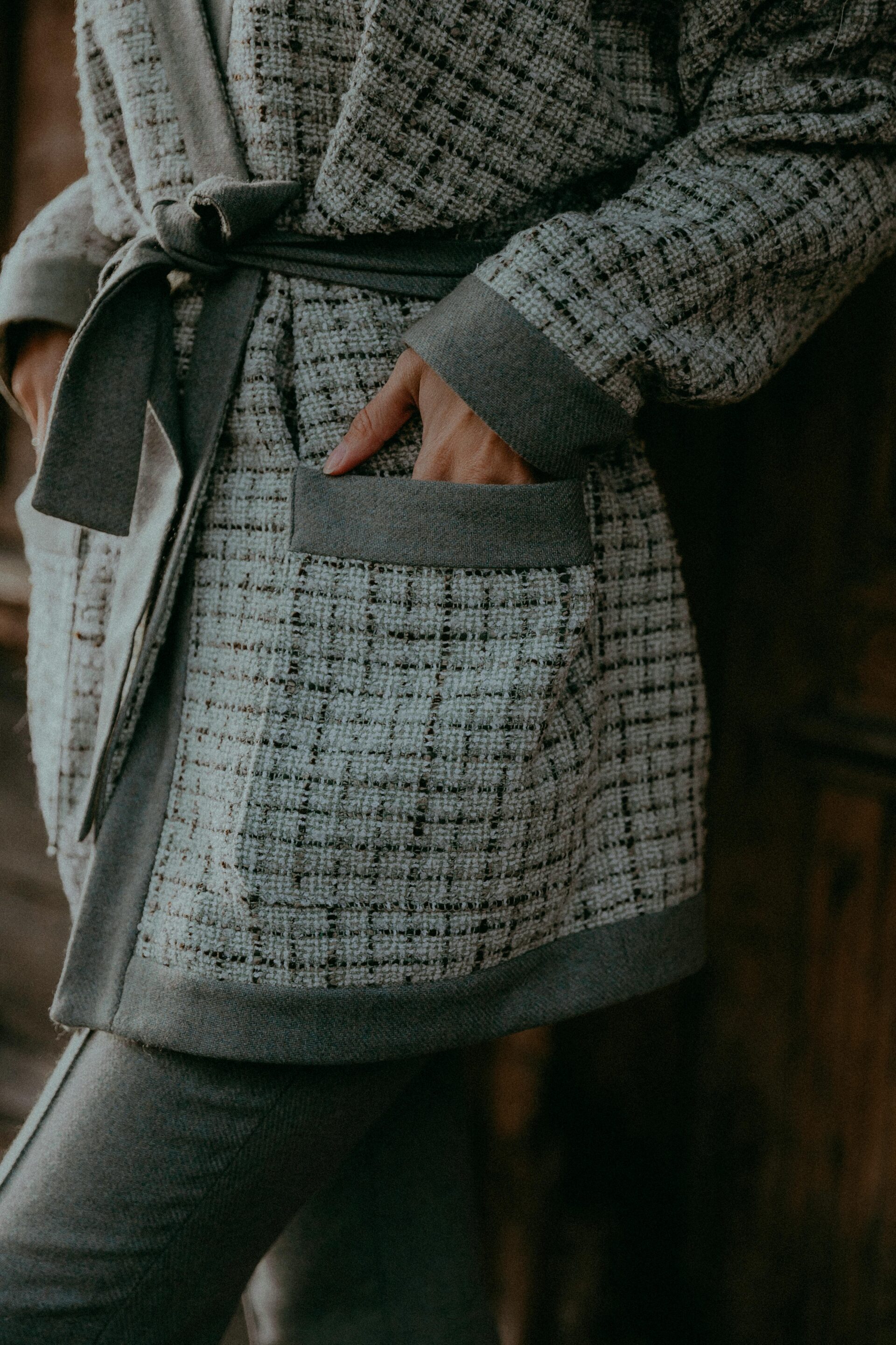 Premium wool blend wrap with textured tweed finish for winter apparel sourcing.