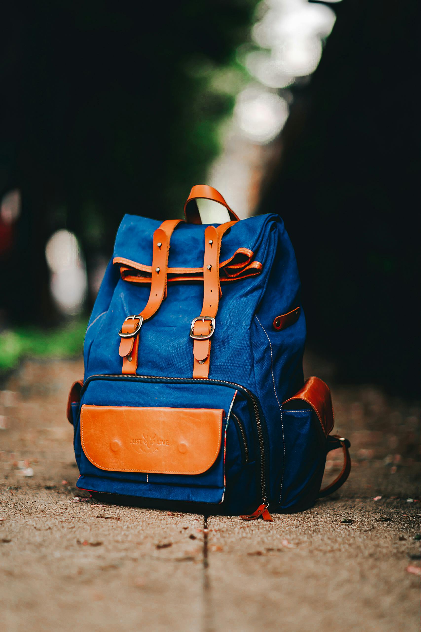 Premium blue canvas backpack with genuine leather straps manufactured by Diamond Attires Bangladesh.