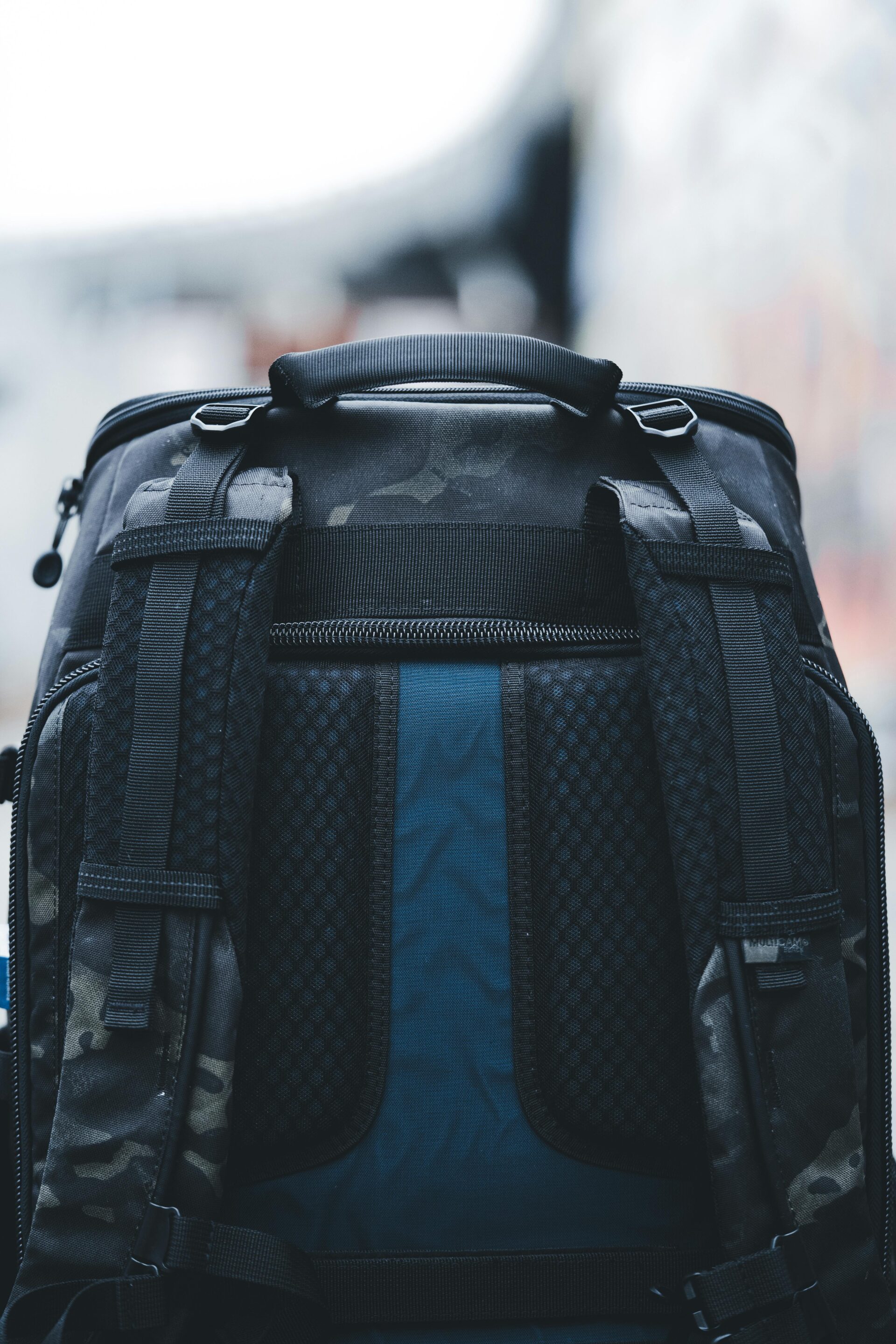 Tactical utility rucksack with breathable mesh back and multi-pocket configuration for industrial use.