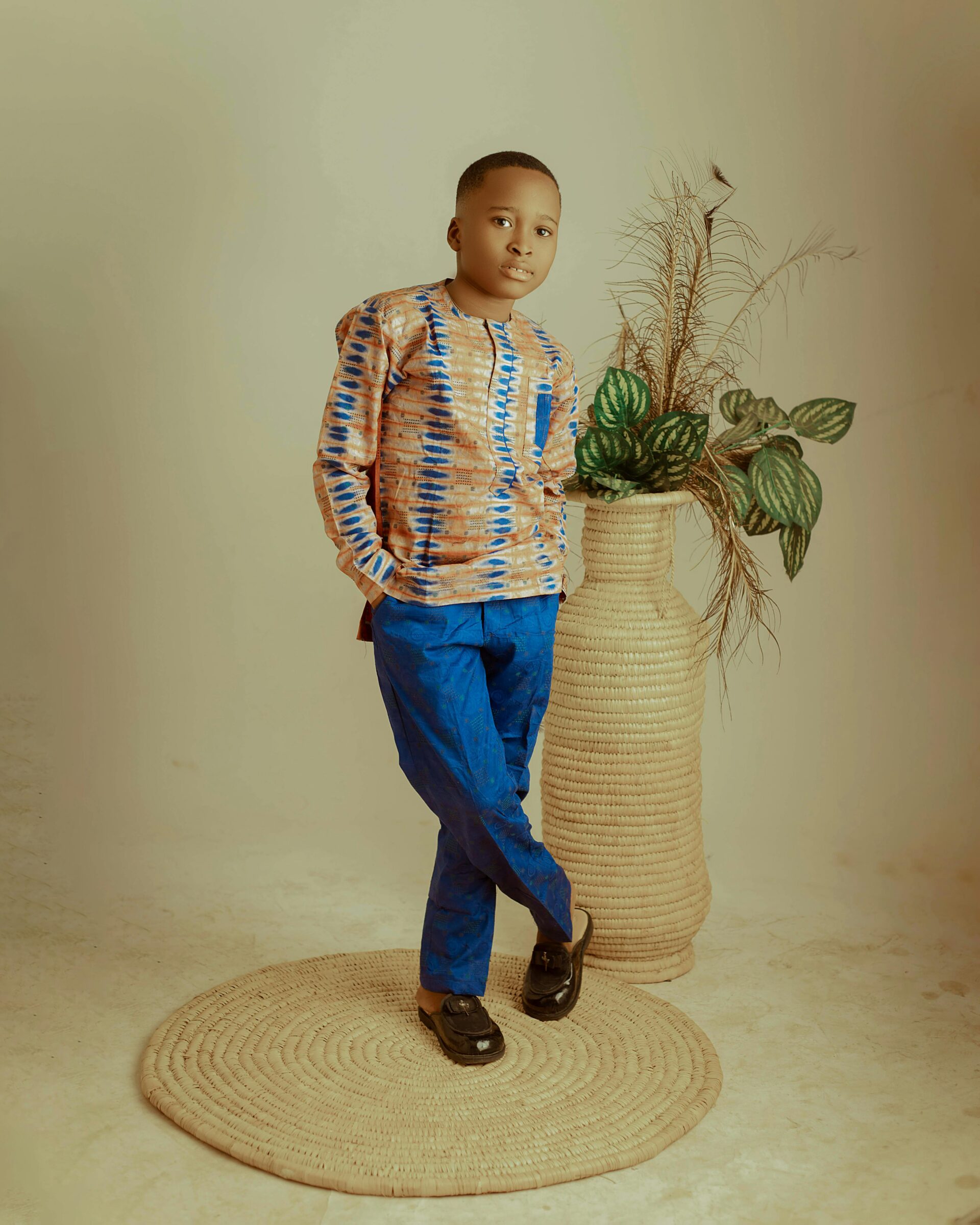 Youth long-sleeve shirt with custom heritage print and blue cotton trousers.